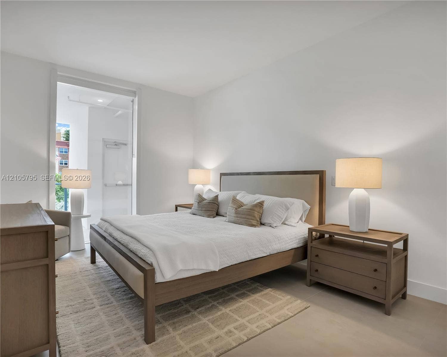407 N Riverside Drive, #202, Pompano Beach, Pompano Beach, FL 33062 Neutral-toned interior featuring smooth wall finishes, wood-finish flooring, and a glass-paneled entry door