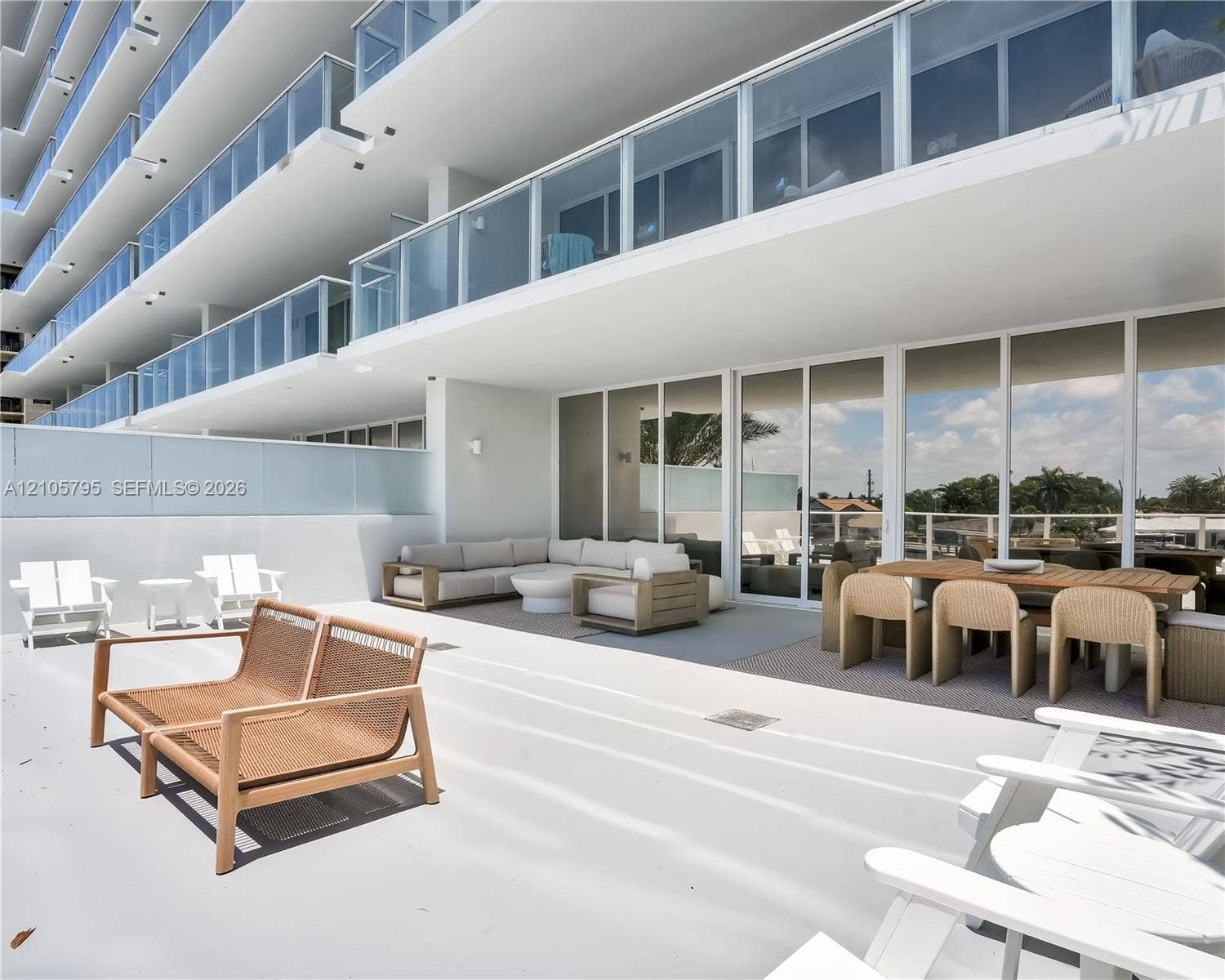 407 N Riverside Drive, #202, Pompano Beach, Pompano Beach, FL 33062 Expansive terrace featuring glass balcony railings, floor-to-ceiling sliding glass doors, and a solid wall perimeter