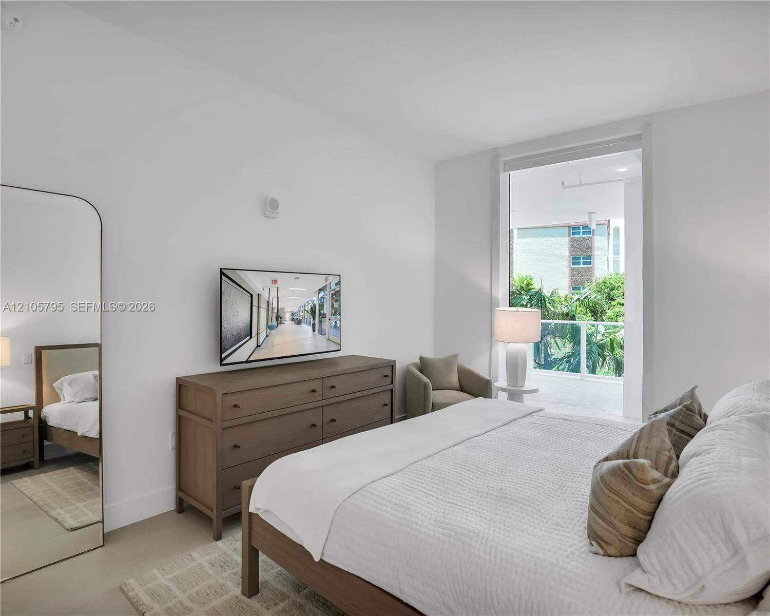407 N Riverside Drive, #202, Pompano Beach, Pompano Beach, FL 33062 Floor-to-ceiling glass door, private balcony with glass railing, and neutral stone-finish flooring