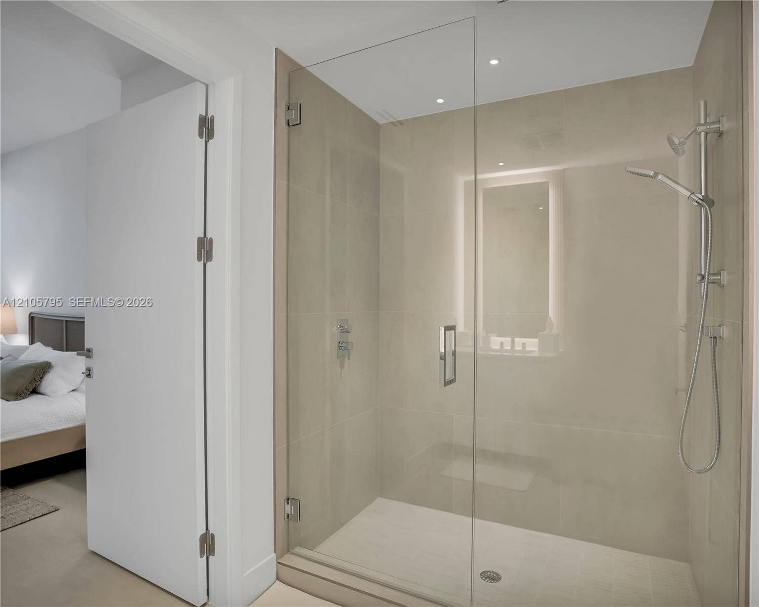 407 N Riverside Drive, #202, Pompano Beach, Pompano Beach, FL 33062 Walk-in shower featuring a frameless glass door, large-format tile surround, chrome hand-held shower fixture, and recessed lighting