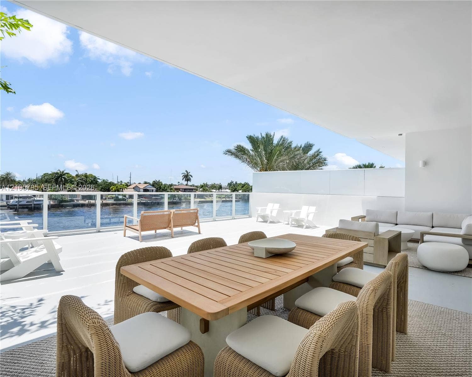 407 N Riverside Drive, #202, Pompano Beach, Pompano Beach, FL 33062 Expansive covered terrace featuring light-toned flooring, glass panel railings, and direct water frontage