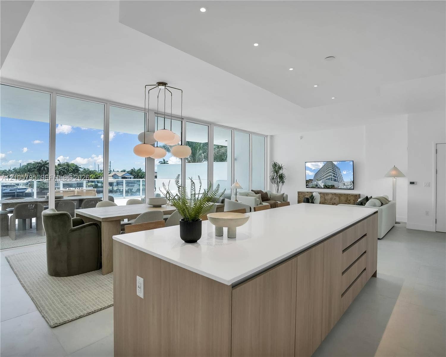 407 N Riverside Drive, #202, Pompano Beach, Pompano Beach, FL 33062 Open-concept interior featuring floor-to-ceiling windows, recessed lighting, expansive center island with solid-surface countertop, and flat-panel wood-finish cabinetry