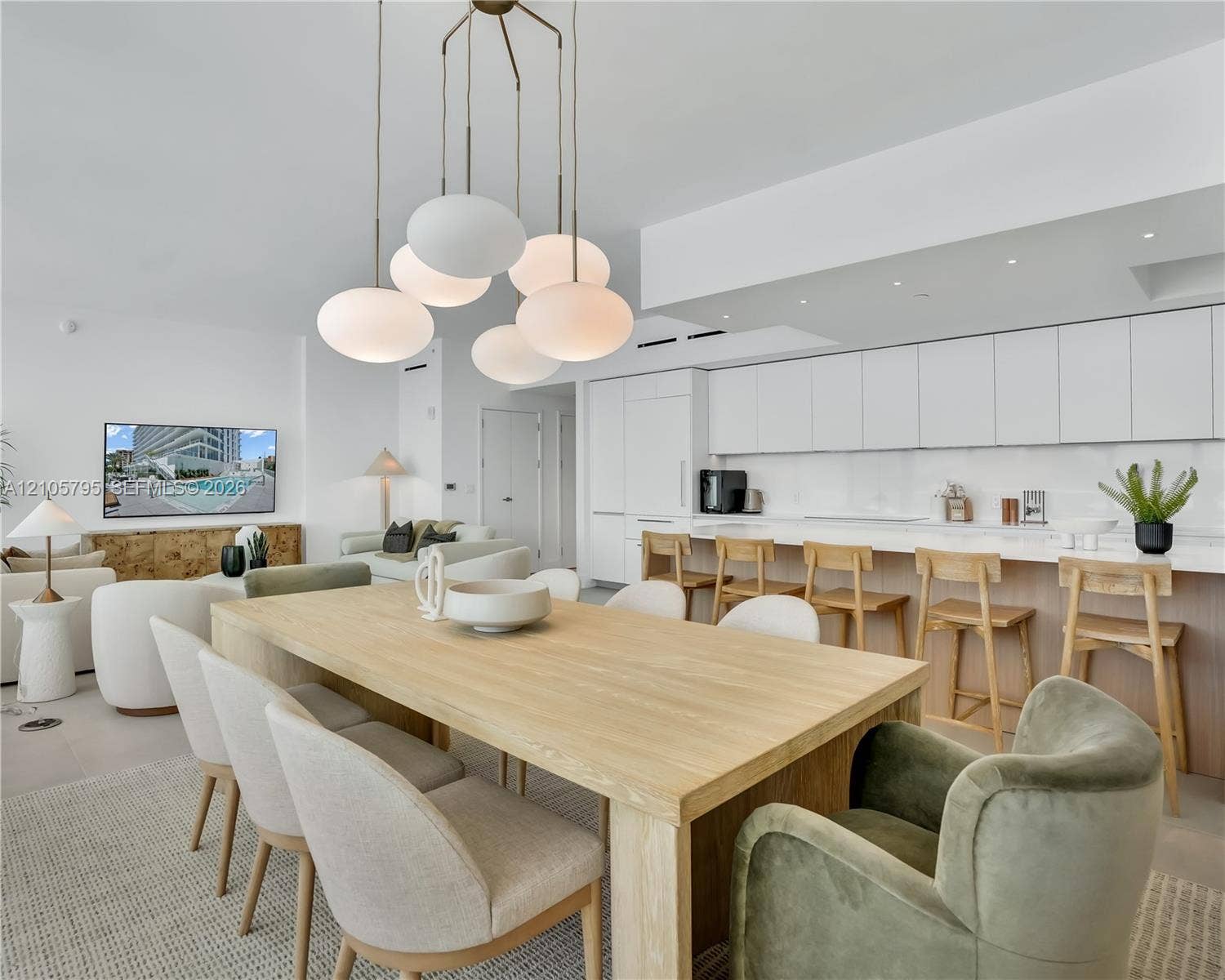 407 N Riverside Drive, #202, Pompano Beach, Pompano Beach, FL 33062 Modern kitchen featuring floor-to-ceiling flat-panel cabinetry, a solid-surface waterfall edge island, and recessed lighting