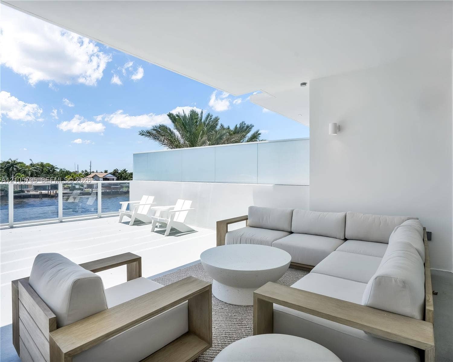 407 N Riverside Drive, #202, Pompano Beach, Pompano Beach, FL 33062 Expansive covered terrace featuring glass-panel railings, solid surface flooring, and integrated wall-mounted lighting