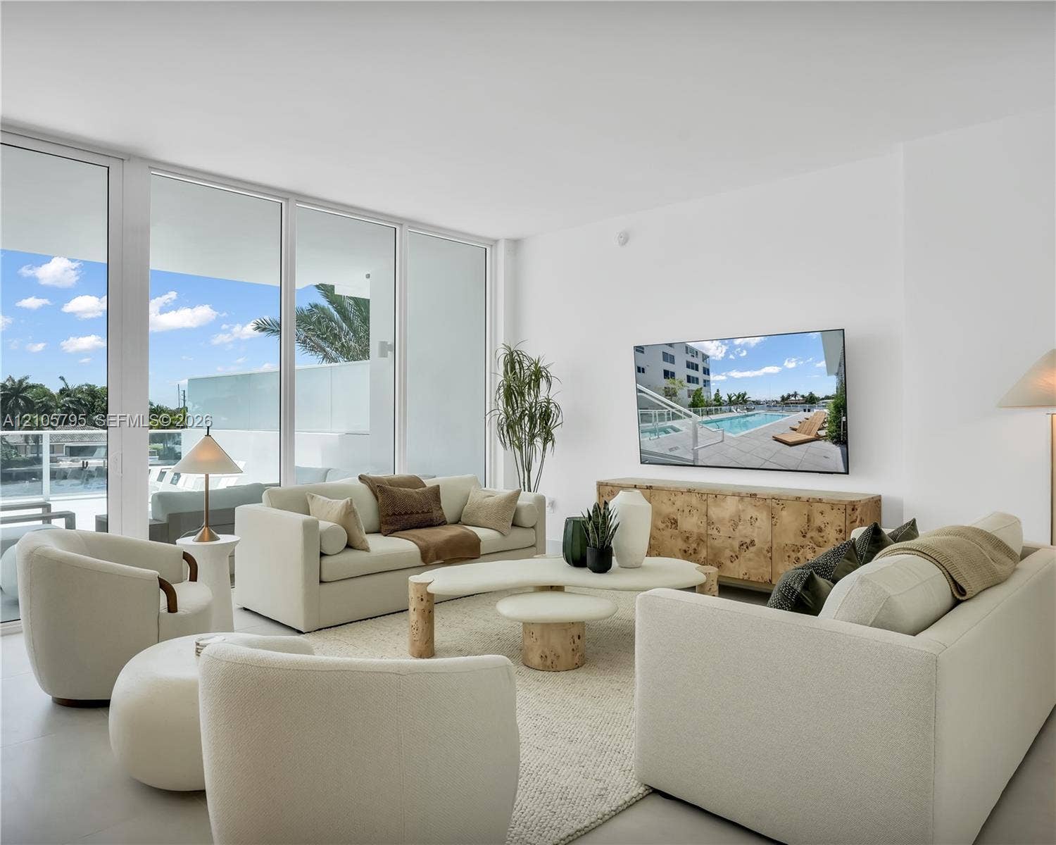 407 N Riverside Drive, #202, Pompano Beach, Pompano Beach, FL 33062 Floor-to-ceiling glass sliding doors, neutral large-format flooring, and direct access to a balcony
