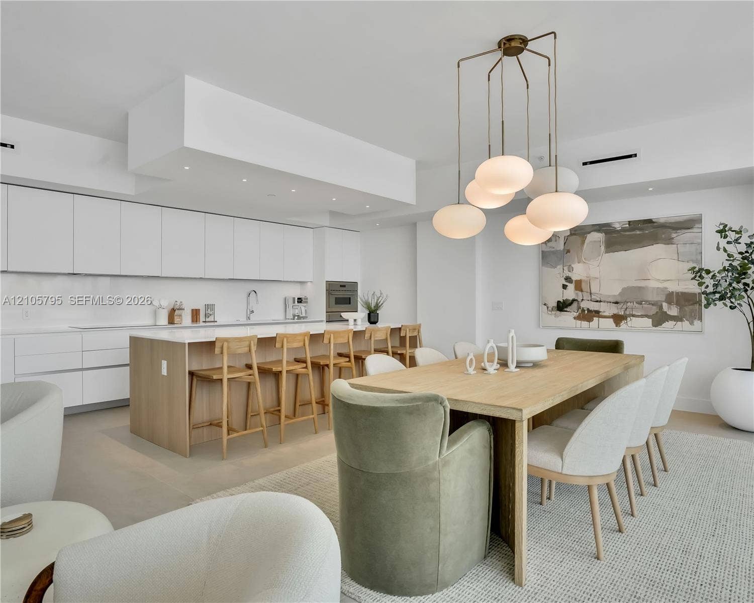 407 N Riverside Drive, #202, Pompano Beach, Pompano Beach, FL 33062 Kitchen featuring flat-panel cabinetry, a spacious island with quartz countertops, integrated built-in appliances, recessed lighting, and a modern multi-pendant light fixture