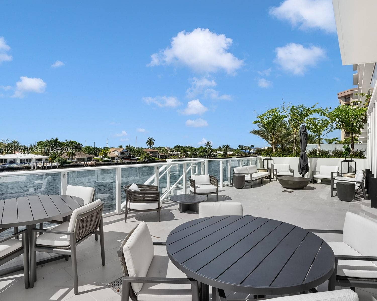 407 N Riverside Drive, #202, Pompano Beach, Pompano Beach, FL 33062 Expansive terrace featuring large-format tile flooring, a glass-panel railing system, and direct waterfront exposure