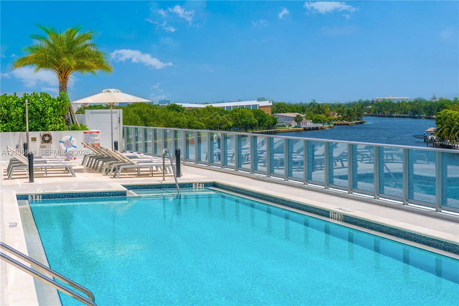 1180 N Federal Highway, #810, Fort Lauderdale, FL 33304 Heated Swimming pool with tile surround, glass panel railing, and paved sun deck