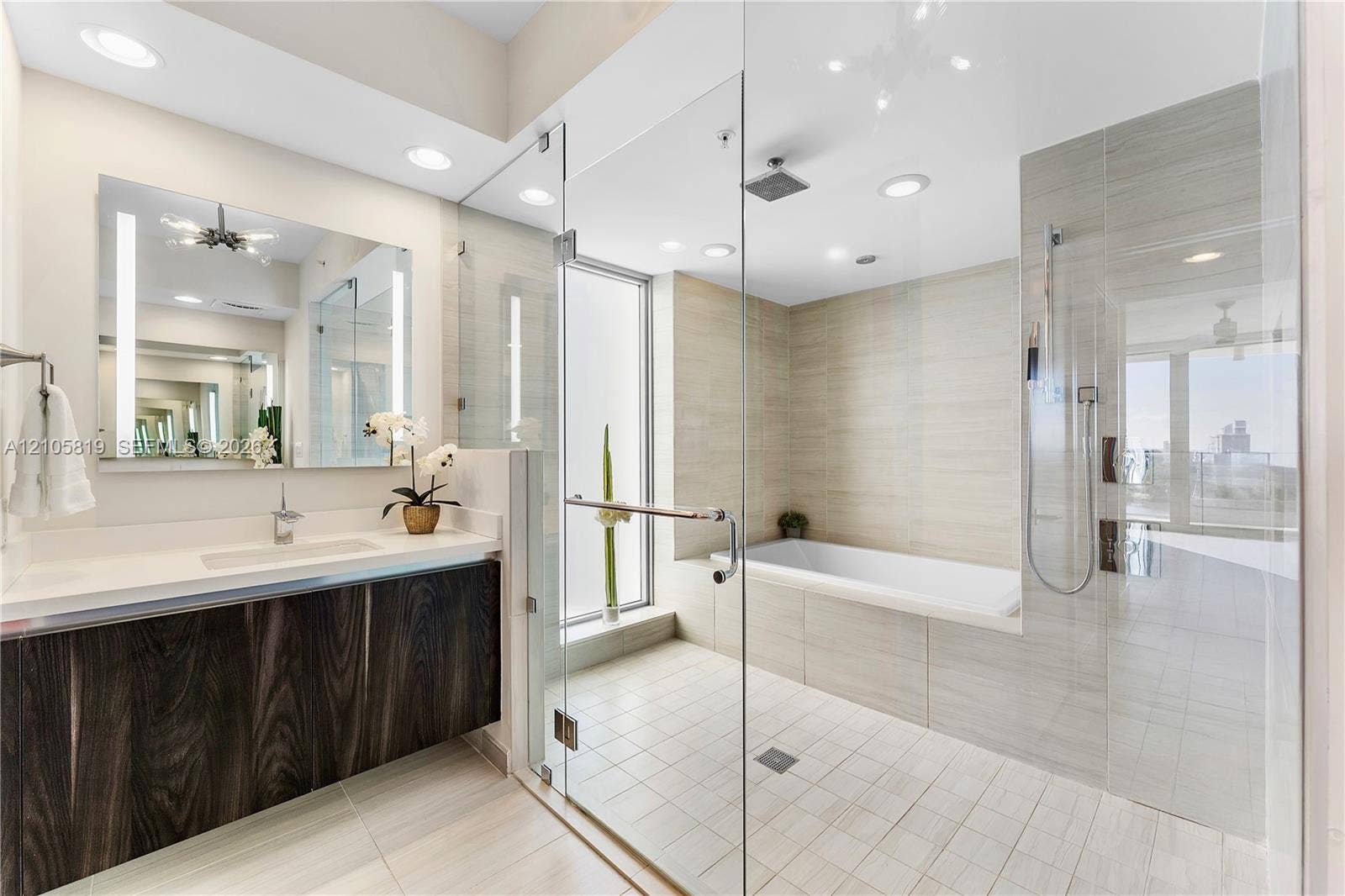 1180 N Federal Highway, #810, Fort Lauderdale, FL 33304 Primary Bathroom with Dual Backlit Sinks, Glass enclosed Shower & Tub as well as Hidden Water Closet.