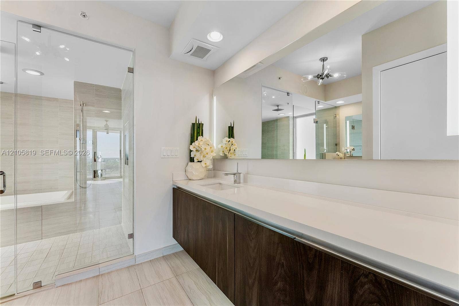 1180 N Federal Highway, #810, Fort Lauderdale, FL 33304 Primary Bathroom with Dual Backlit Sinks, Glass enclosed Shower & Tub as well as Hidden Water Closet.