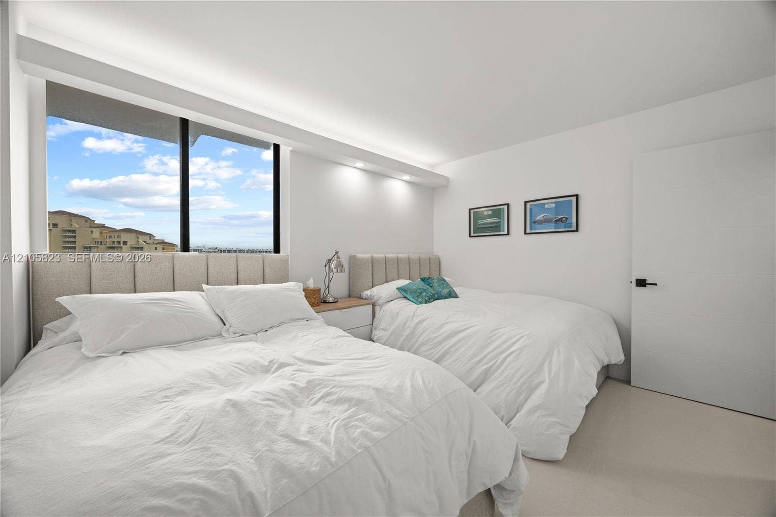 Room featuring recessed lighting, a large window with exterior scenery, neutral carpeted flooring, and a flat-panel interior door with matte black hardware