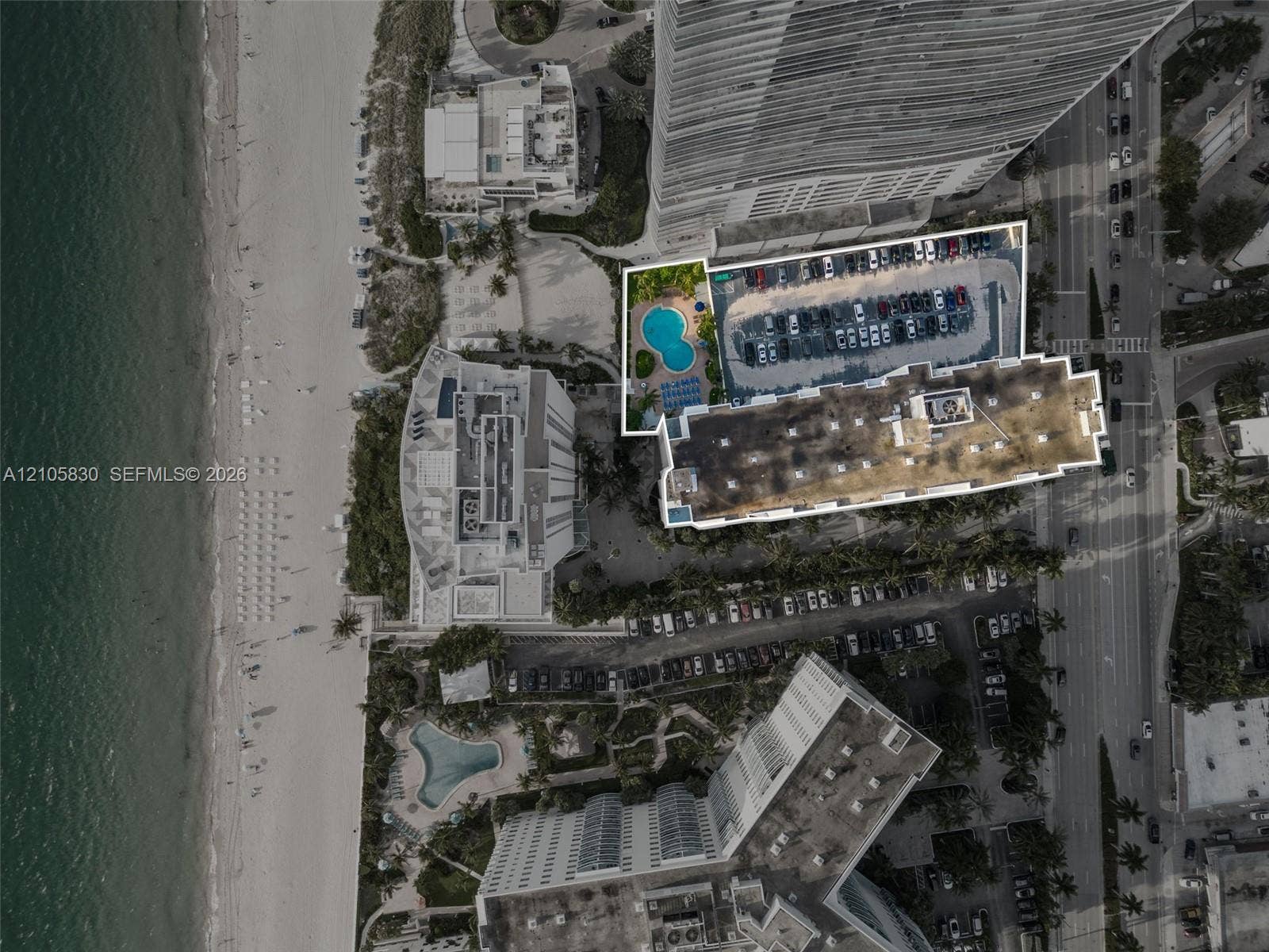 4001 S Ocean Drive, #14F, Hollywood, Hollywood, FL 33019 Aerial perspective of oceanfront property featuring a dedicated swimming pool, surface parking area, and direct proximity to the shoreline