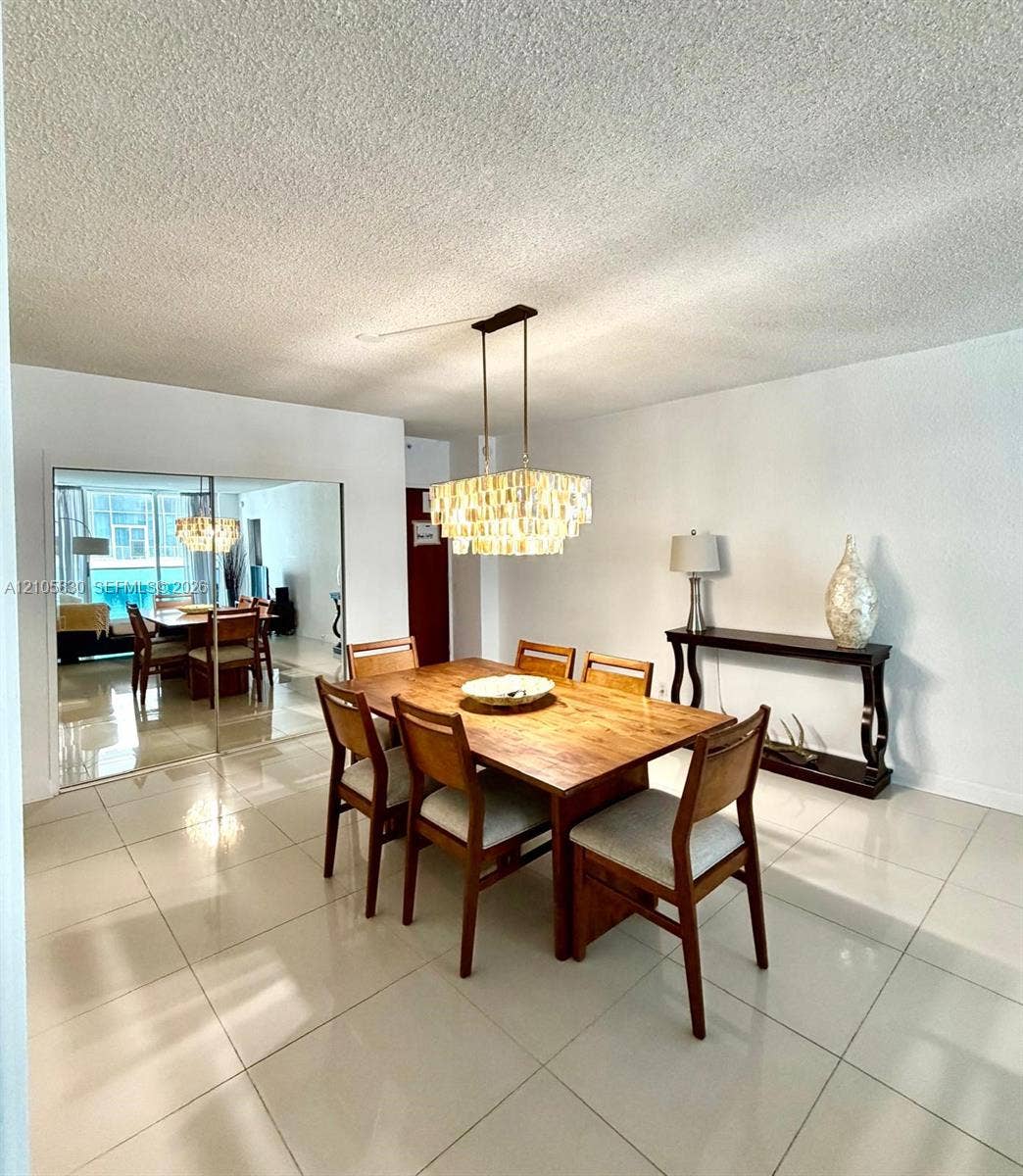 4001 S Ocean Drive, #14F, Hollywood, Hollywood, FL 33019 Large-format tile flooring, tiered crystal chandelier, and floor-to-ceiling mirrored closet doors