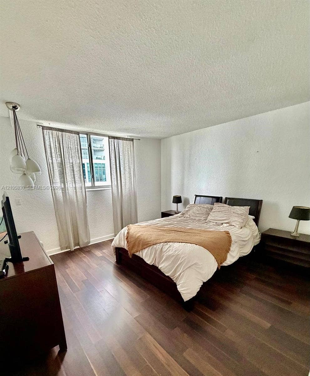 4001 S Ocean Drive, #14F, Hollywood, Hollywood, FL 33019 Wood-finish flooring, multi-globe pendant lighting, and a large window with natural light