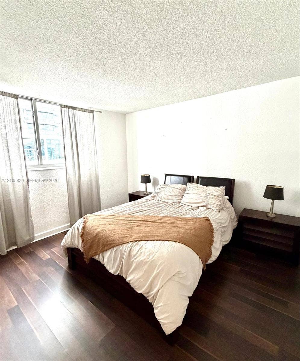 4001 S Ocean Drive, #14F, Hollywood, Hollywood, FL 33019 Dark-tone wood-finish flooring and single-pane window with metal frame