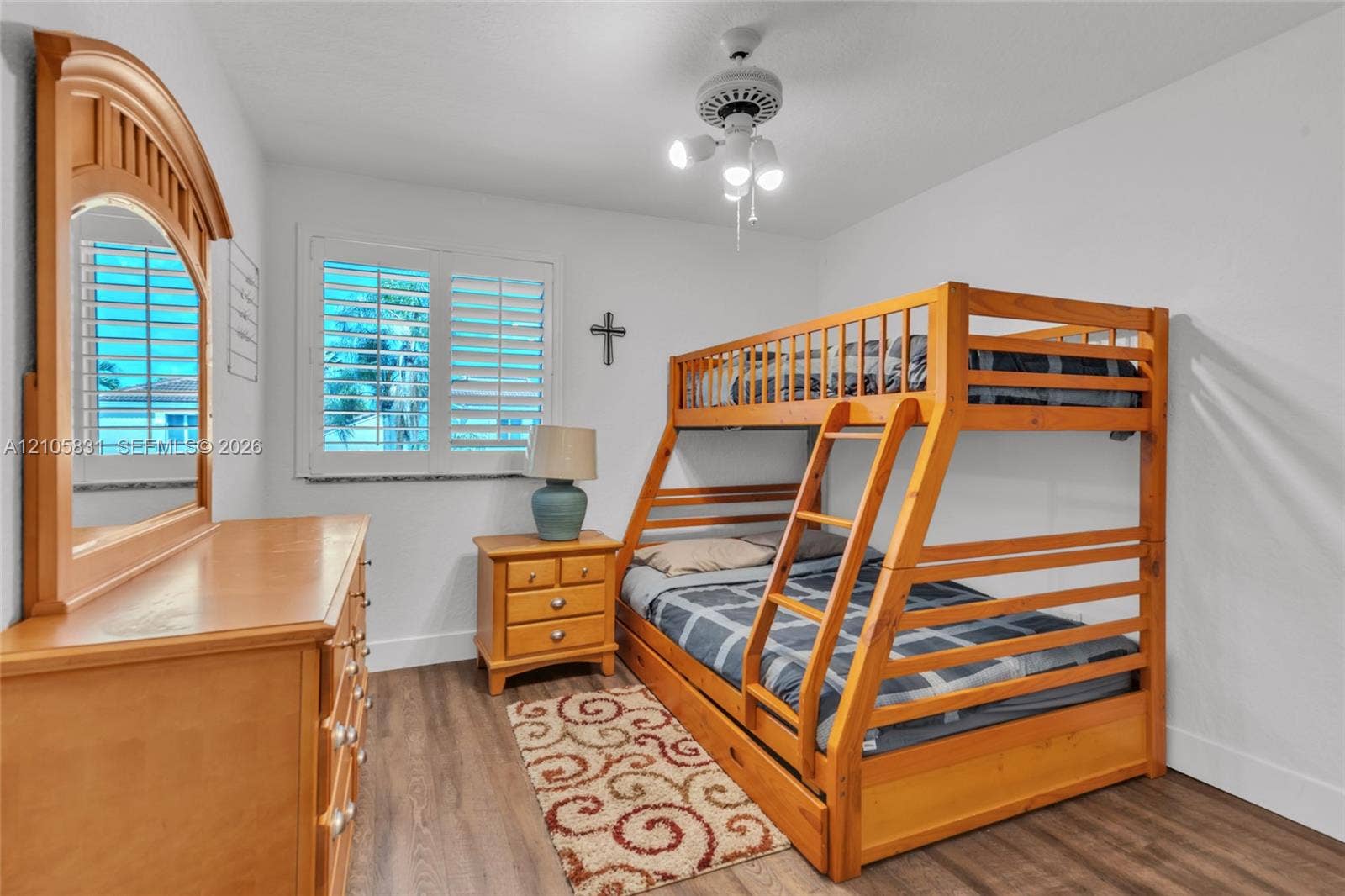 15612 SW 16th Court, Pembroke Pines, FL 33027 Interior room featuring wood-finish flooring, white plantation shutters, and a multi-light ceiling fan