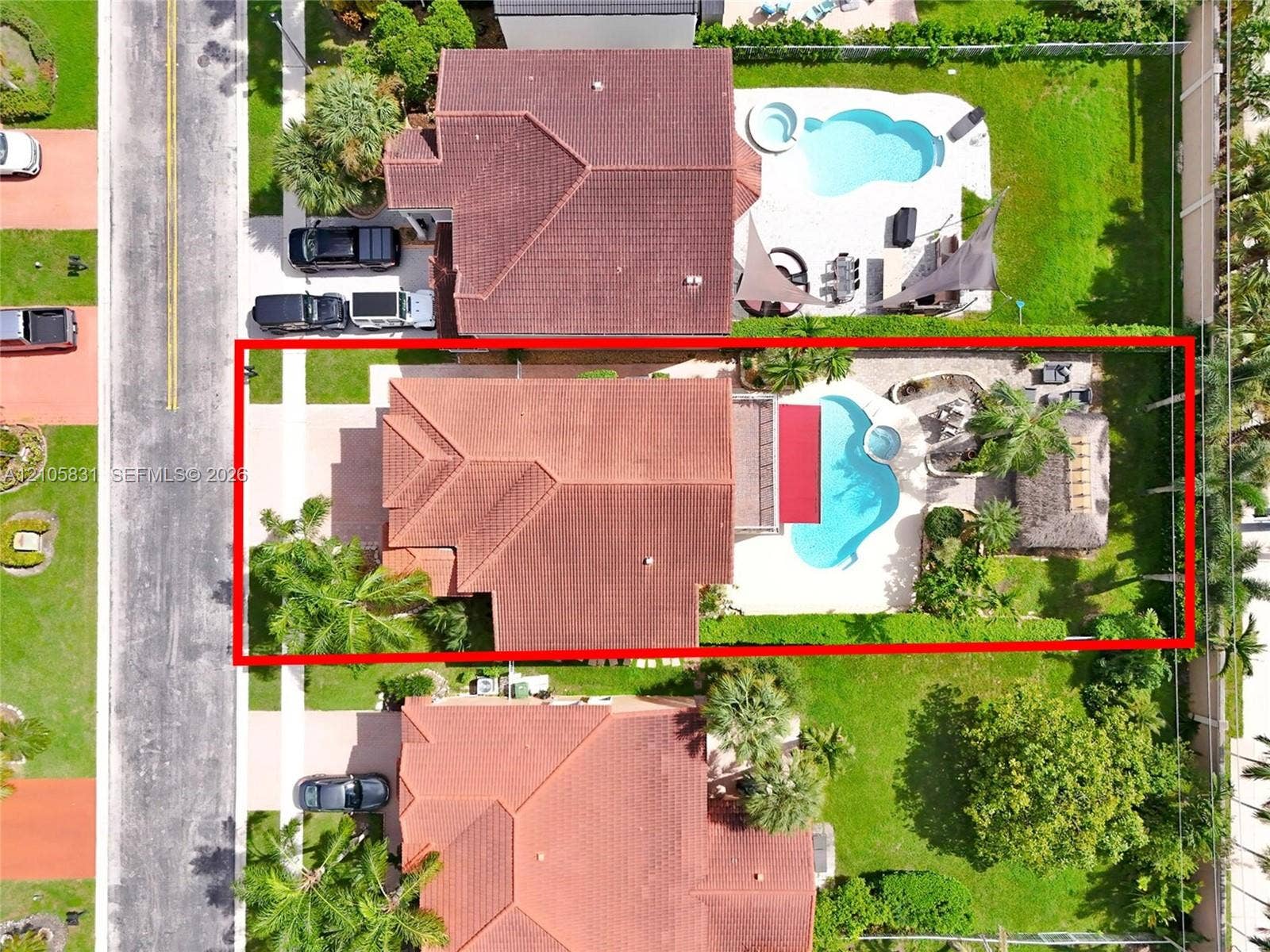 15612 SW 16th Court, Pembroke Pines, FL 33027 Aerial perspective of a property featuring a swimming pool, integrated spa, paved pool deck, and a detached palapa