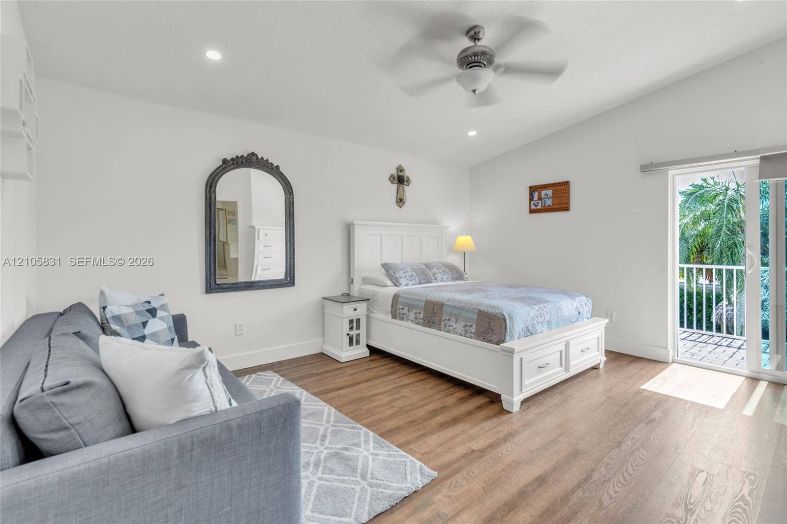 15612 SW 16th Court, Pembroke Pines, FL 33027 Vaulted ceilings with a central fan, wood-finish flooring, and sliding glass doors with direct exterior access