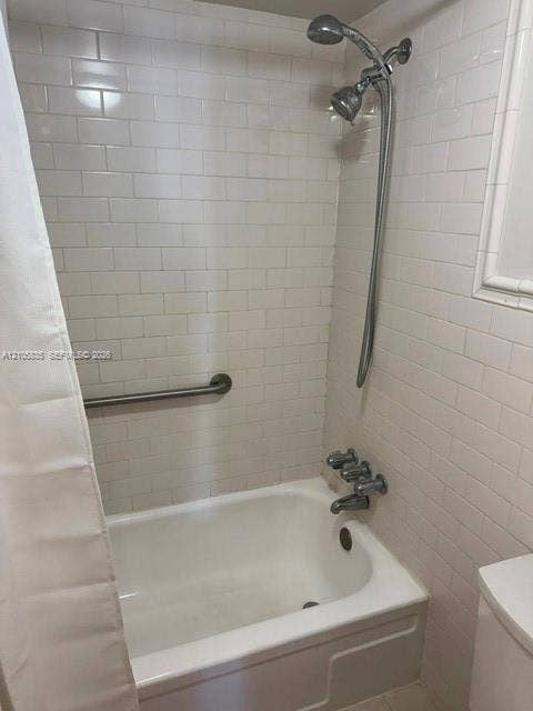 1400 S Ocean Drive, #1503, Hollywood, Hollywood, FL 33019 Bathtub and shower combination featuring white subway tile surround, polished chrome fixtures, and wall-mounted grab bar