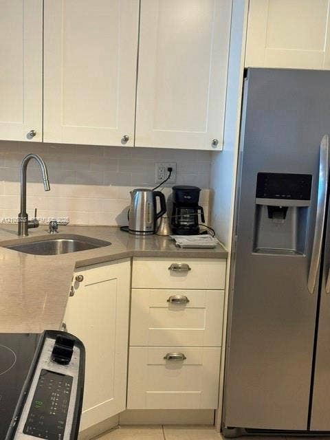 1400 S Ocean Drive, #1503, Hollywood, Hollywood, FL 33019 Shaker-style white cabinetry, stone-finish countertops, stainless steel side-by-side refrigerator, under-mount stainless steel sink, and arched-neck faucet