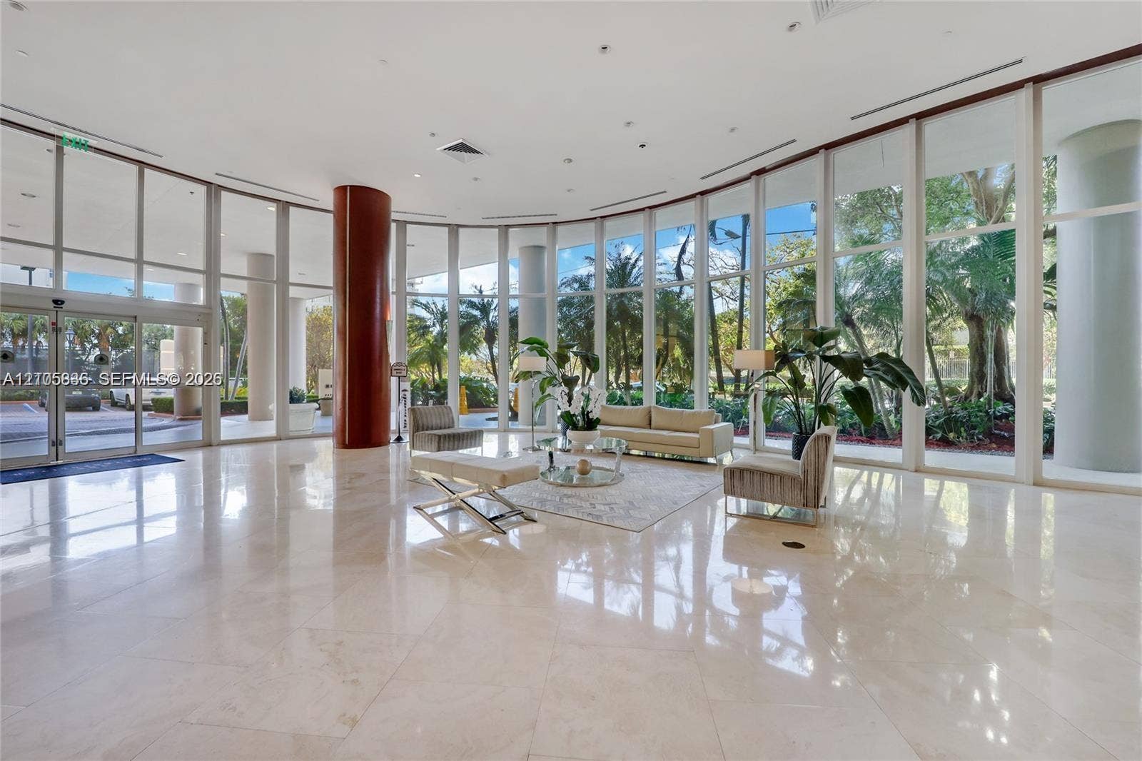 2475 Brickell Avenue, #704, Miami, FL 33129 Expansive lobby featuring floor-to-ceiling glass walls, polished stone flooring, and structural columns