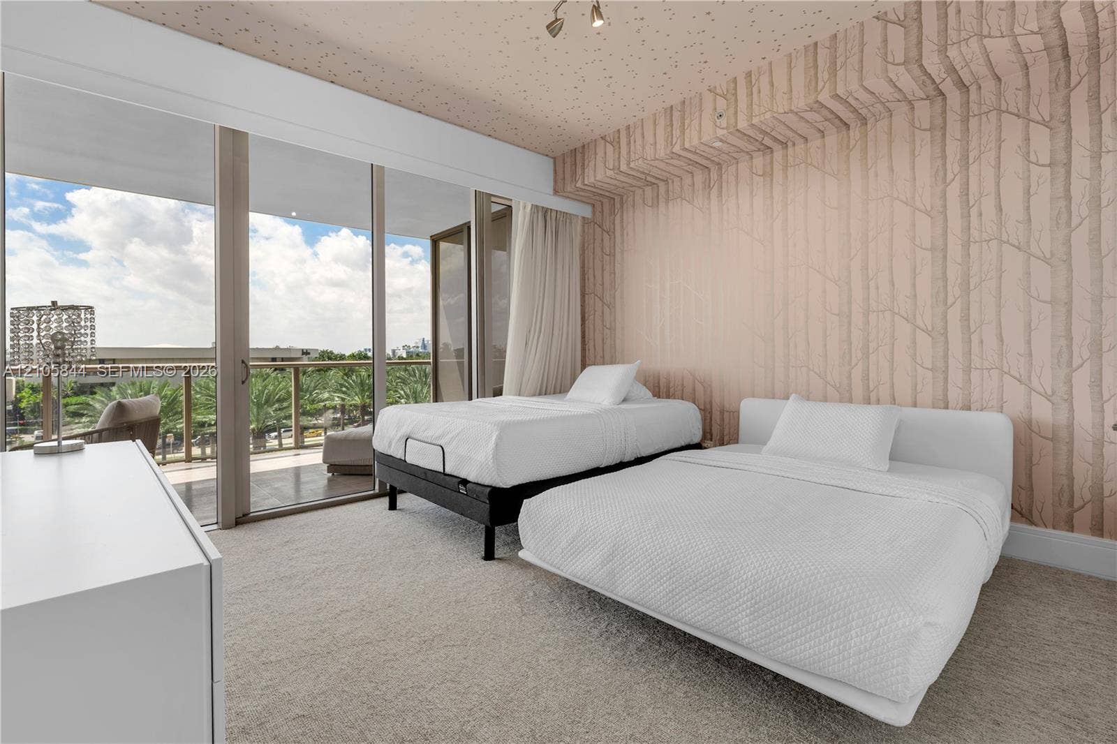 Bal Harbour, Bal Harbour, FL 33154 Floor-to-ceiling glass sliding doors, private balcony with metal railing, wall-to-wall carpeting, and floor-to-ceiling patterned wall coverings