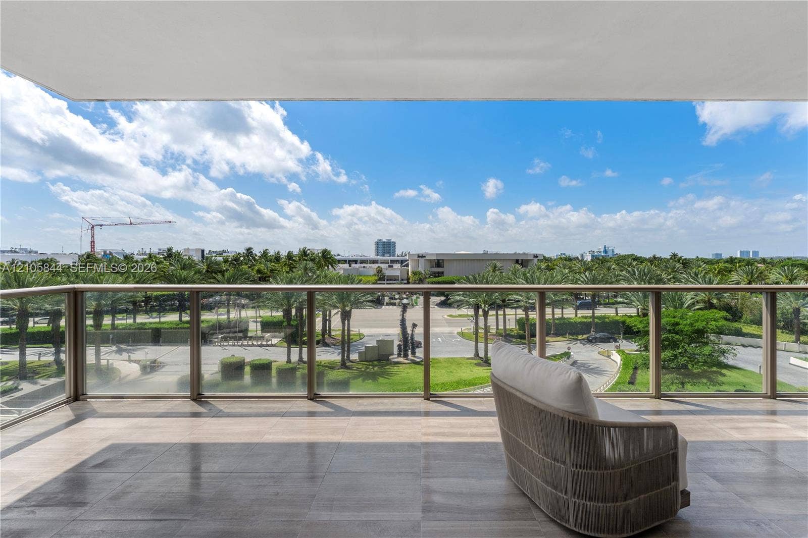Bal Harbour, Bal Harbour, FL 33154 Covered balcony featuring tile flooring and a glass-panel railing