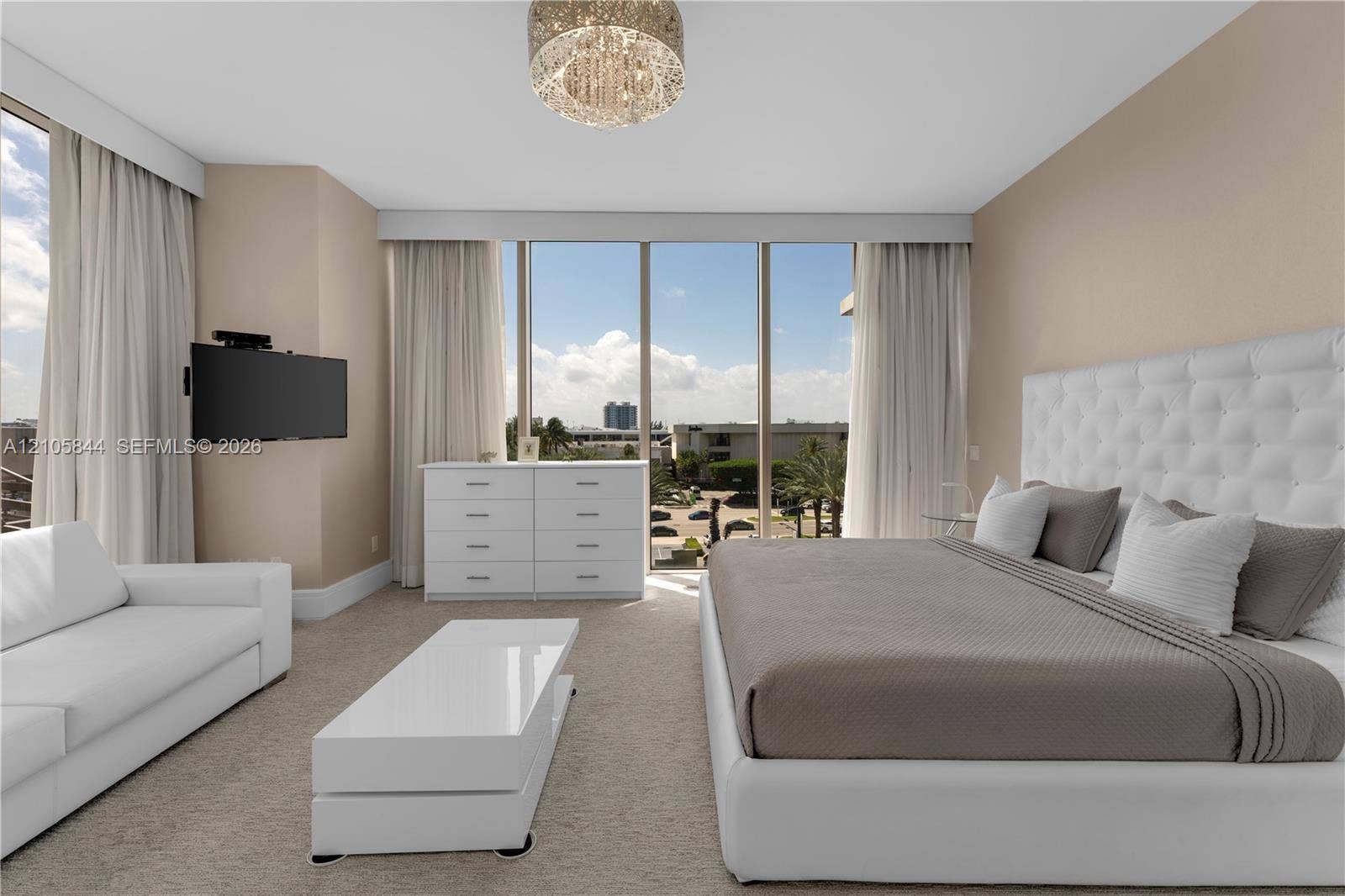 Bal Harbour, Bal Harbour, FL 33154 Floor-to-ceiling windows, neutral carpeting, recessed ceiling lighting, and a crystal-style chandelier