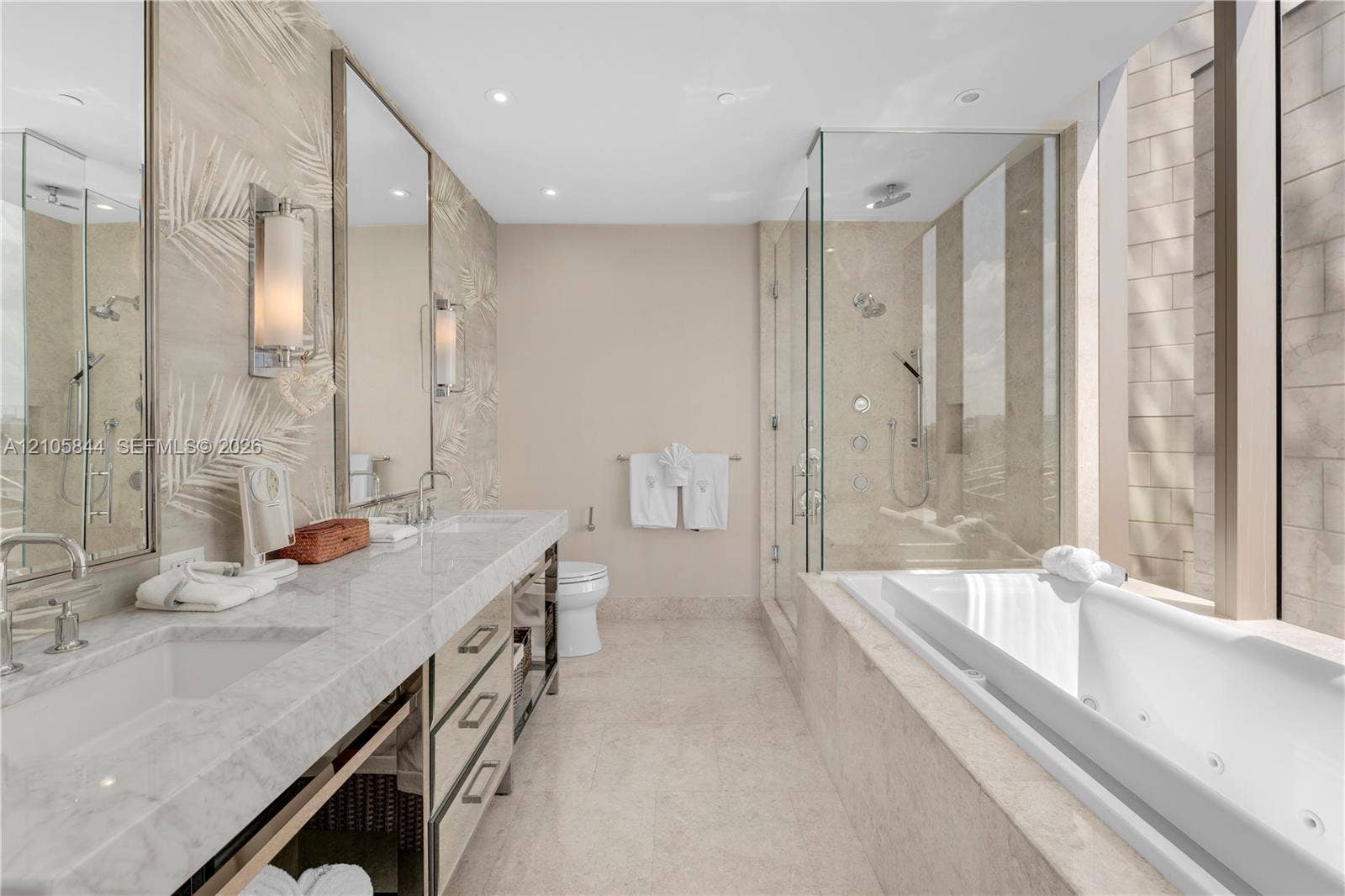 Bal Harbour, Bal Harbour, FL 33154 Dual vanity with stone-surfaced countertop, frameless glass-enclosed shower featuring multi-head fixtures, and built-in jetted soaking tub