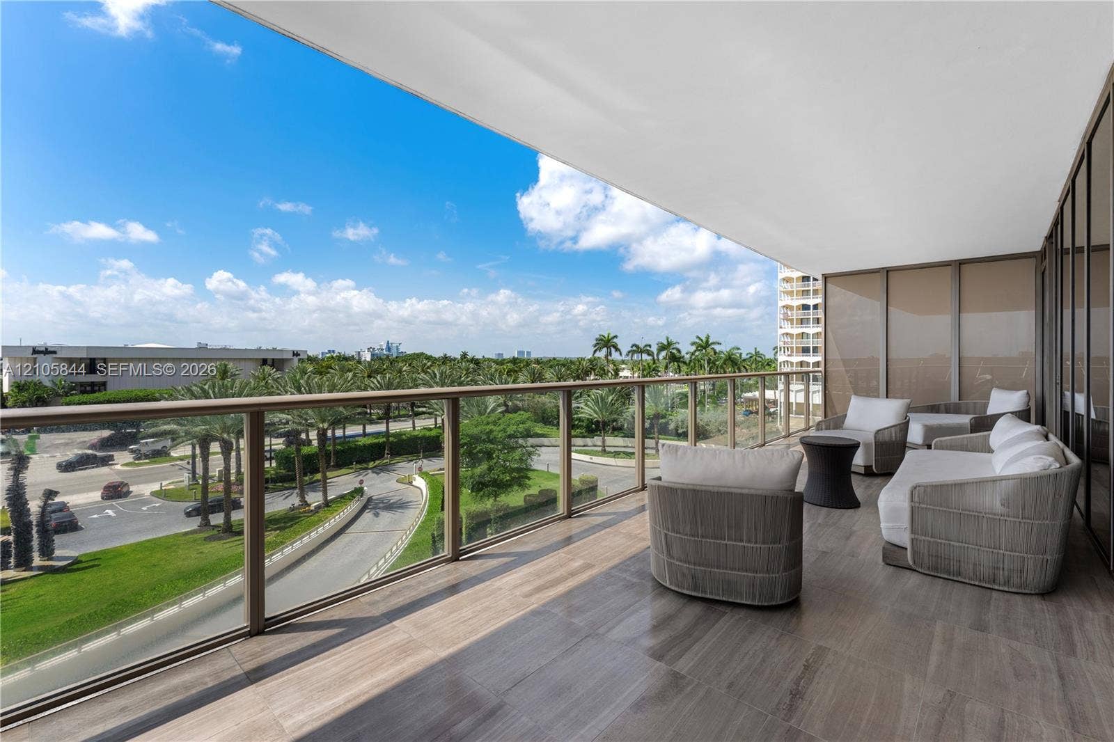 Bal Harbour, Bal Harbour, FL 33154 Expansive covered balcony featuring tile flooring and a metal-framed glass railing
