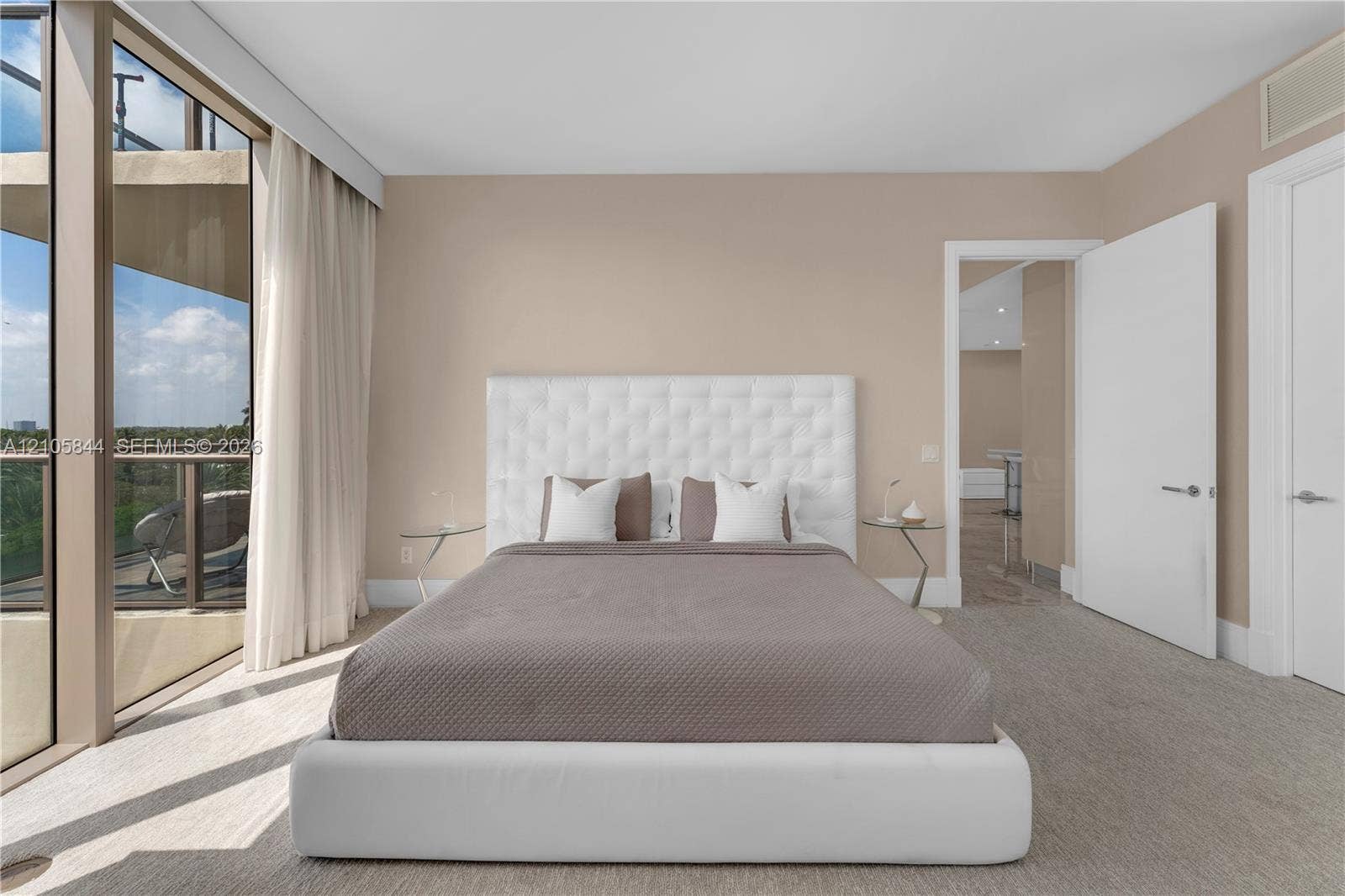 Bal Harbour, Bal Harbour, FL 33154 Floor-to-ceiling glass wall, private balcony with metal railing, neutral carpeting, and solid-core interior doors