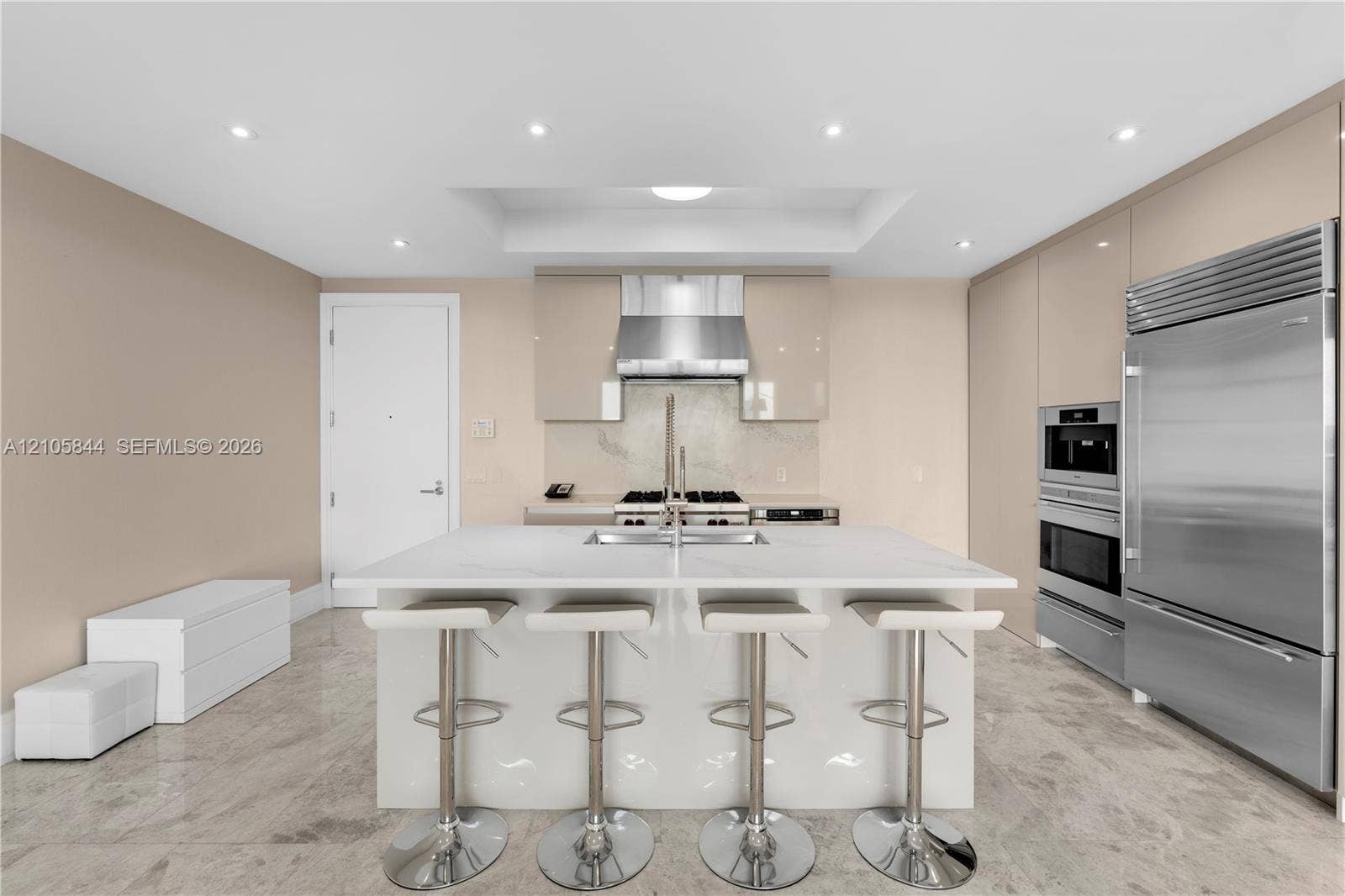 Bal Harbour, Bal Harbour, FL 33154 Kitchen featuring a central island with quartz countertop, high-gloss cabinetry, stainless steel professional-grade appliances, recessed lighting, and stone flooring