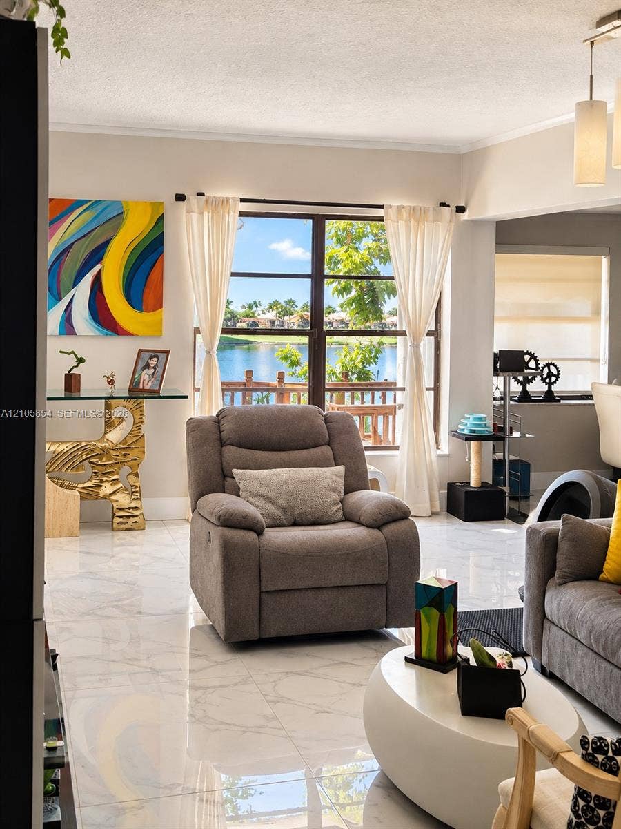 454 NW 97th Place, Miami, FL 33172 Large picture window featuring water scenery, polished stone-finish tile flooring, and a multi-pendant ceiling light fixture