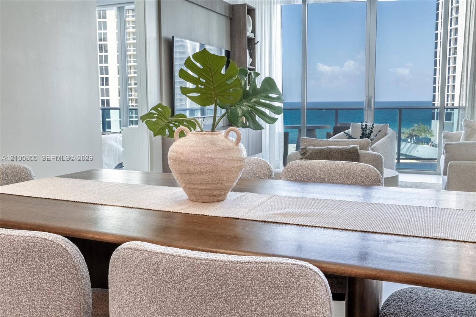 17550 Collins Avenue, #703, Sunny Isles Beach, Sunny Isles Beach, FL 33160 Floor-to-ceiling glass wall, private balcony with metal railing, and ocean horizon backdrop