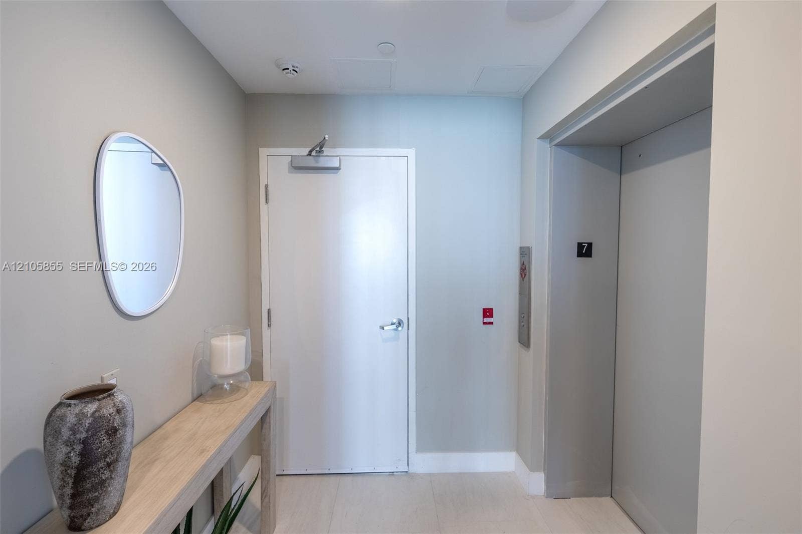 17550 Collins Avenue, #703, Sunny Isles Beach, Sunny Isles Beach, FL 33160 Entrance foyer featuring a solid-core entry door with hydraulic closer, private elevator access, and light-toned hard-surface flooring