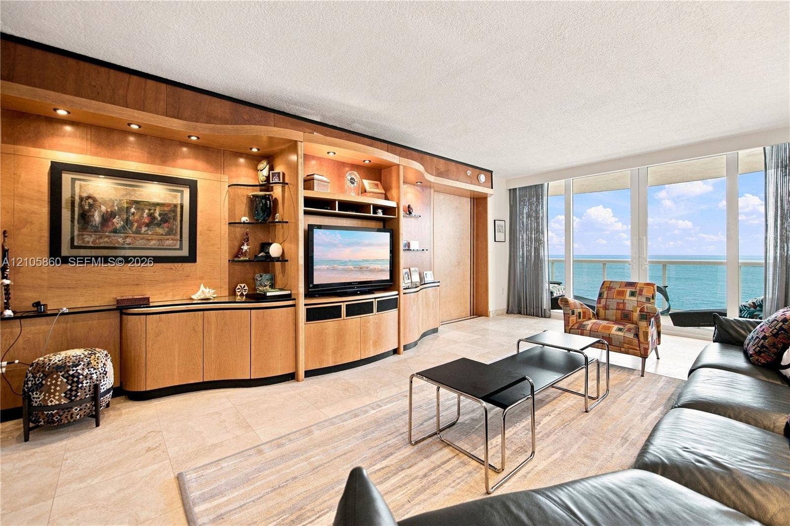 17555 Collins Avenue, #1903, Sunny Isles Beach, FL 33160 Built-in floor-to-ceiling wood cabinetry with integrated lighting, tile flooring, and floor-to-ceiling windows featuring ocean scenery