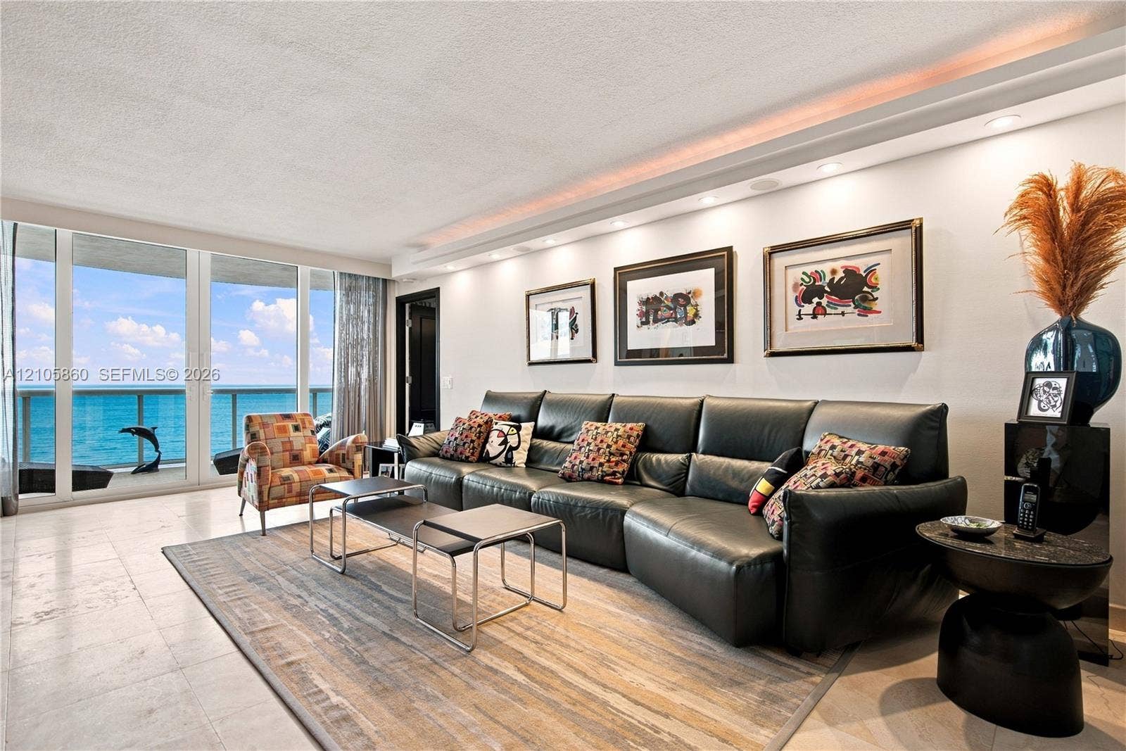17555 Collins Avenue, #1903, Sunny Isles Beach, FL 33160 Floor-to-ceiling glass windows, recessed ceiling lighting with crown molding, polished stone flooring, and expansive water frontage