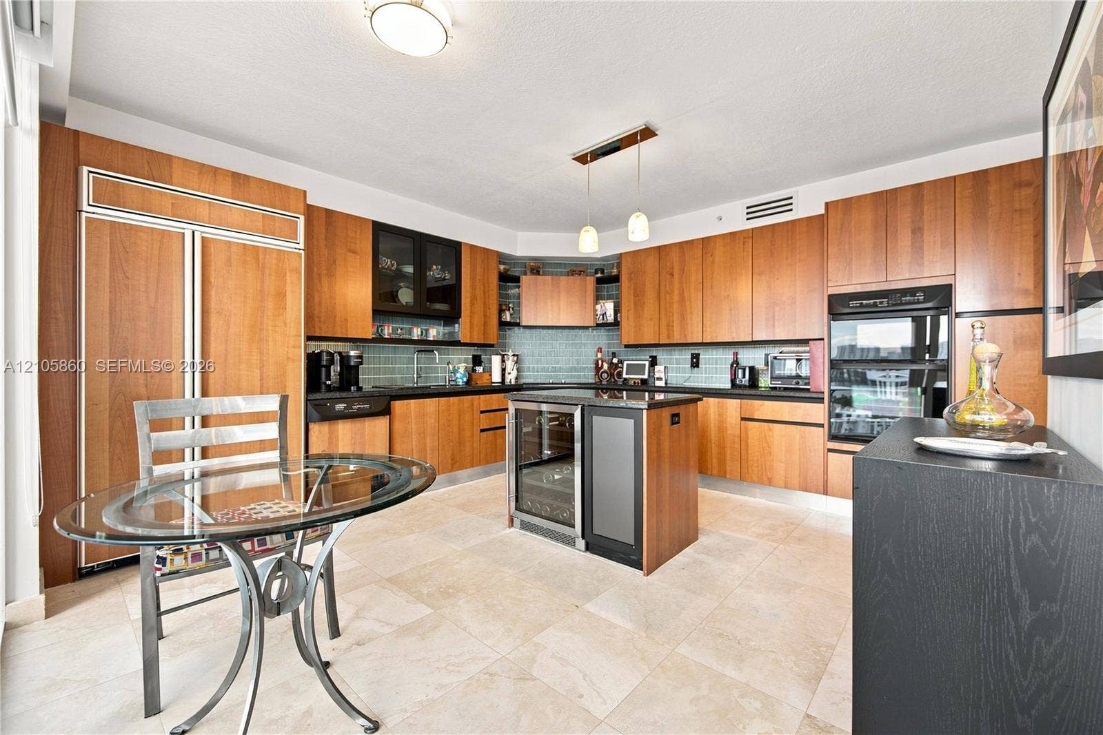 17555 Collins Avenue, #1903, Sunny Isles Beach, FL 33160 Kitchen featuring natural-finish wood cabinetry, dark stone countertops, integrated panel-front appliances, a built-in wine refrigerator, and tile flooring