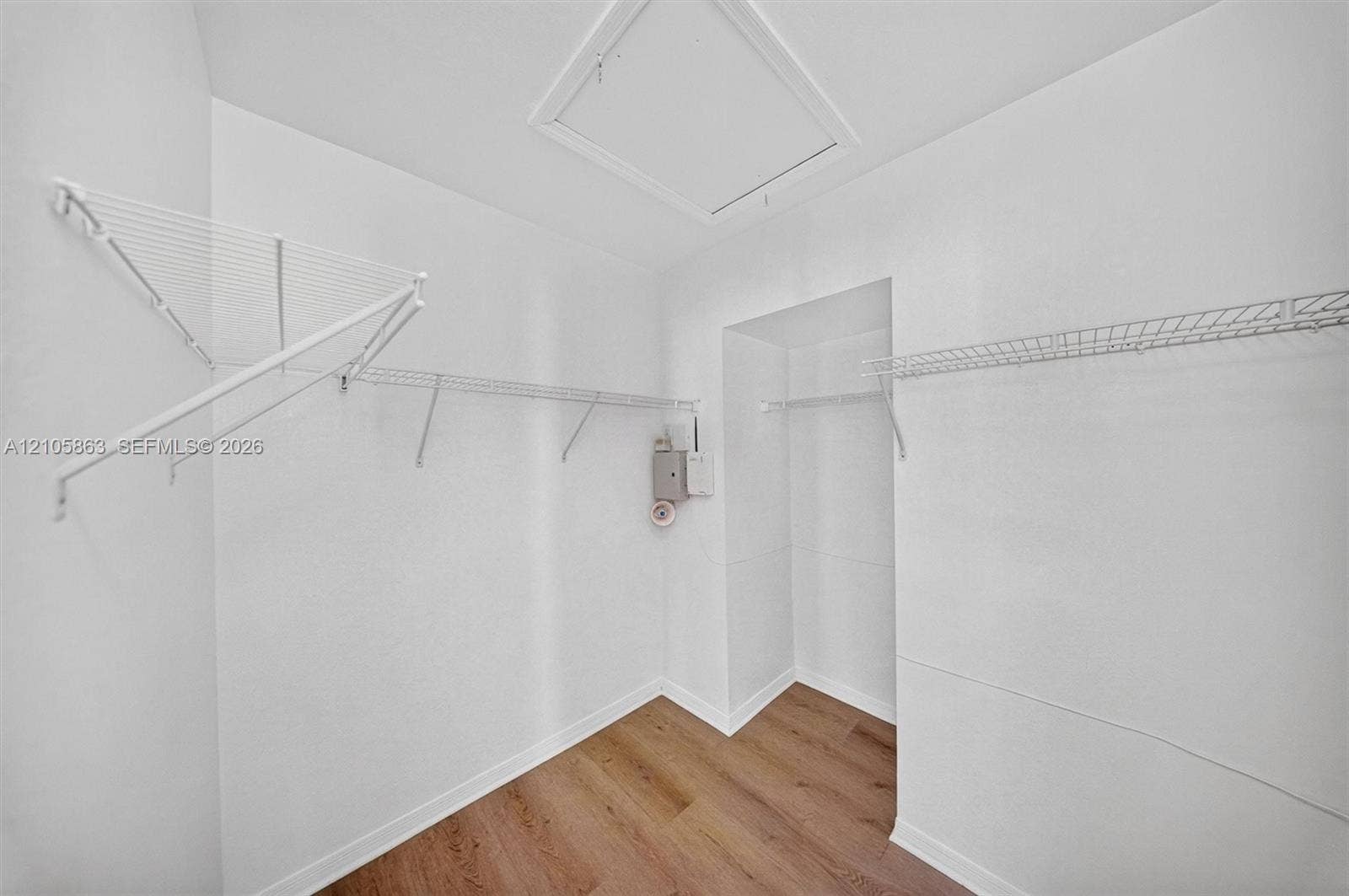 8846 W Flagler Street, #5, Miami, FL 33174 Storage space featuring white wire shelving units, wood-finish flooring, and ceiling access panel