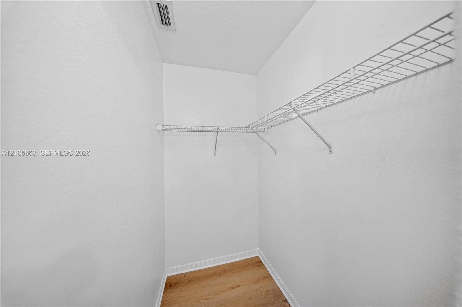 8846 W Flagler Street, #5, Miami, FL 33174 Storage area featuring wood-finish flooring and L-shaped wire shelving