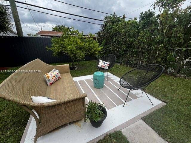 11241 SW 7th Terrace, Sweetwater, FL 33174 Painted concrete patio featuring a fenced rear yard with mature perimeter vegetation