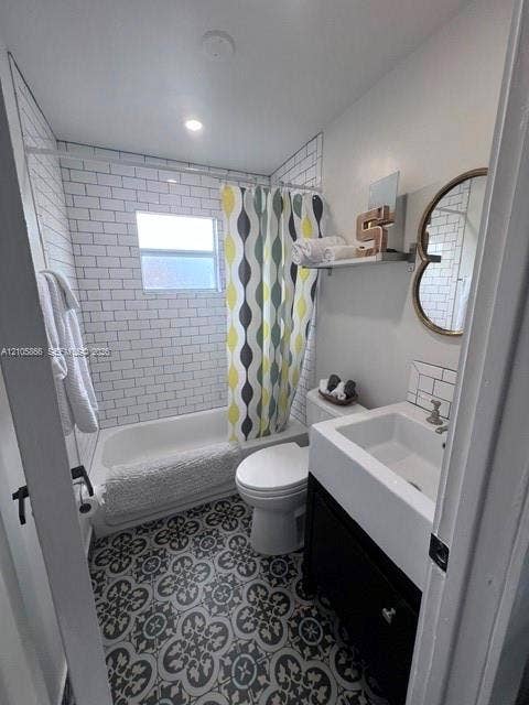 11241 SW 7th Terrace, Sweetwater, FL 33174 1/1 Bathroom featuring patterned floor tile, white subway tile shower surround, porcelain tub, and a vanity cabinet with a rectangular basin
