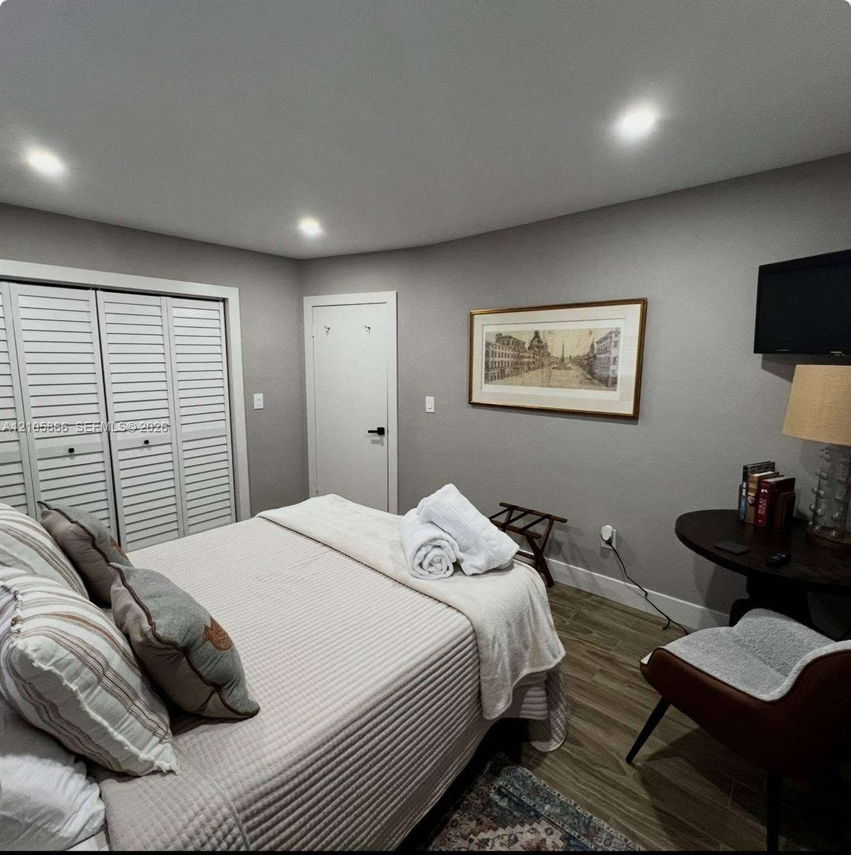 11241 SW 7th Terrace, Sweetwater, FL 33174 main house bedroom 2 Wood-finish flooring, recessed lighting, and white louvered closet doors
