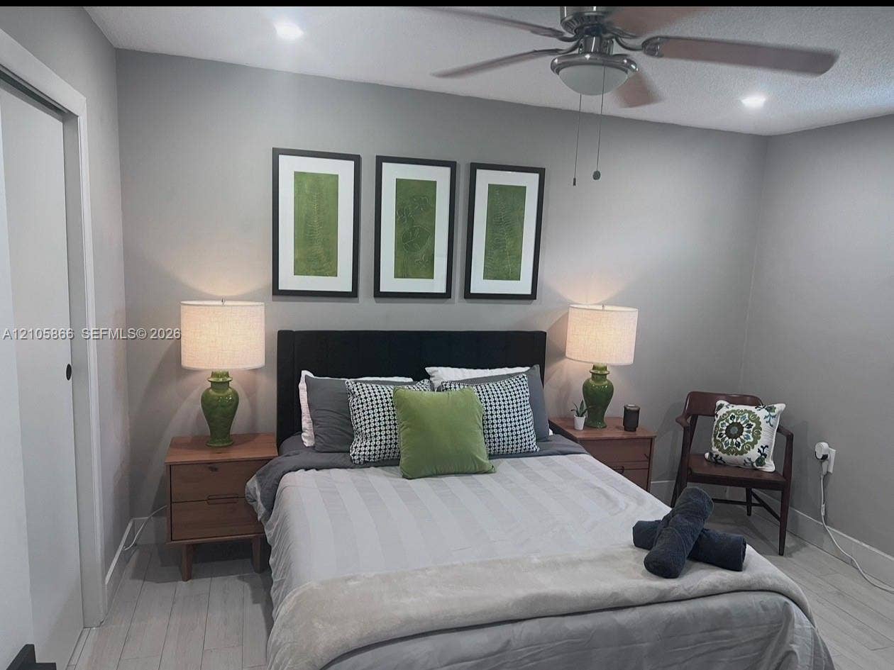 11241 SW 7th Terrace, Sweetwater, FL 33174 Neutral-toned walls paired with light wood-finish flooring and a ceiling-mounted light fixture with an integrated fan