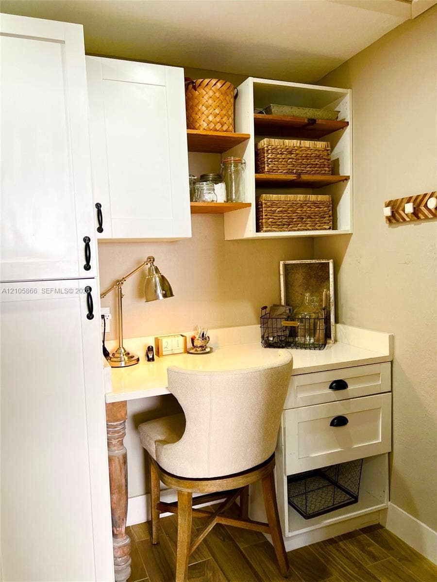 11241 SW 7th Terrace, Sweetwater, FL 33174 Office/Pantry Built-in workspace featuring white shaker-style cabinetry, solid surface countertop, open shelving, and wood-finish flooring