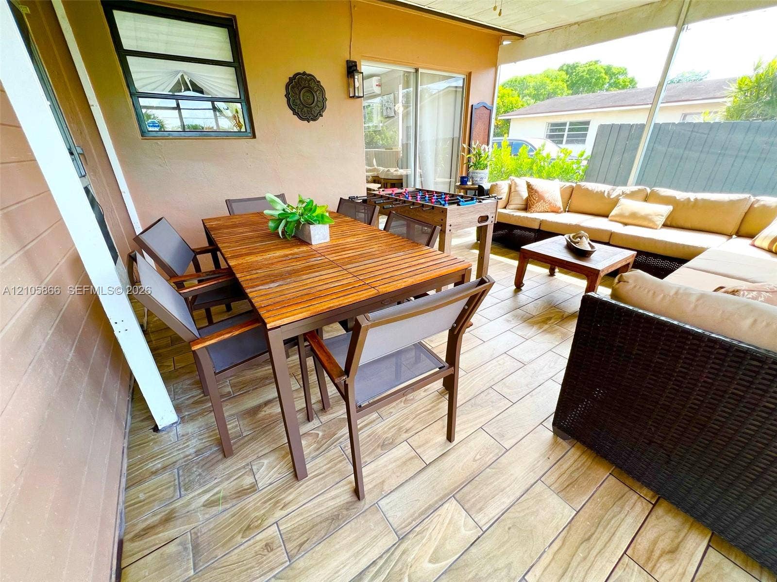 11241 SW 7th Terrace, Sweetwater, FL 33174 Main House's Screened-in patio featuring wood-finish tile flooring, recessed ceiling lighting, and sliding glass door access