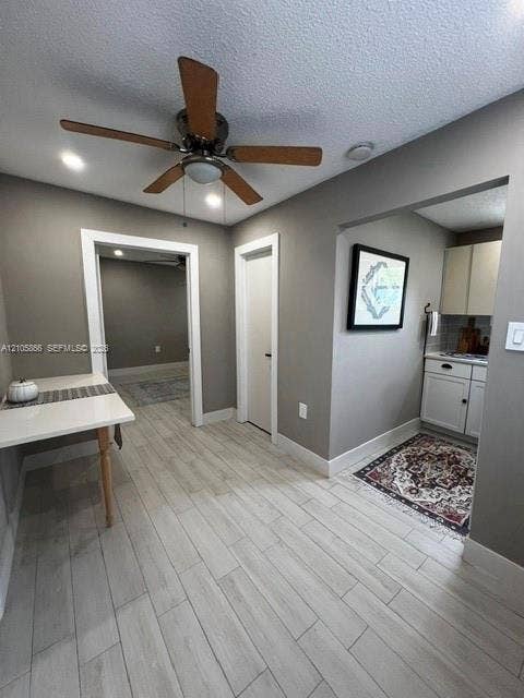 11241 SW 7th Terrace, Sweetwater, FL 33174 1/1 Interior space featuring neutral wall tones, wood-finish flooring, a ceiling fan with light fixture, and built-in cabinetry