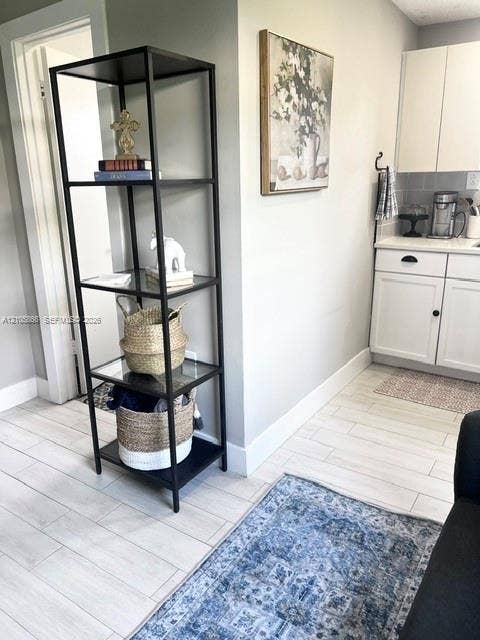 11241 SW 7th Terrace, Sweetwater, FL 33174 1/1 area White solid-surface countertop with wood-finish flooring and a central ceiling fan