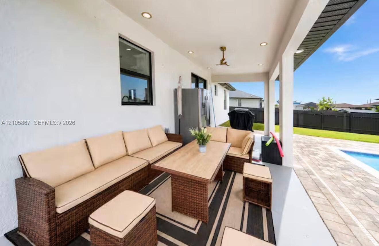 Covered patio featuring recessed ceiling lighting, a mounted ceiling fan, smooth finished walls, and concrete flooring