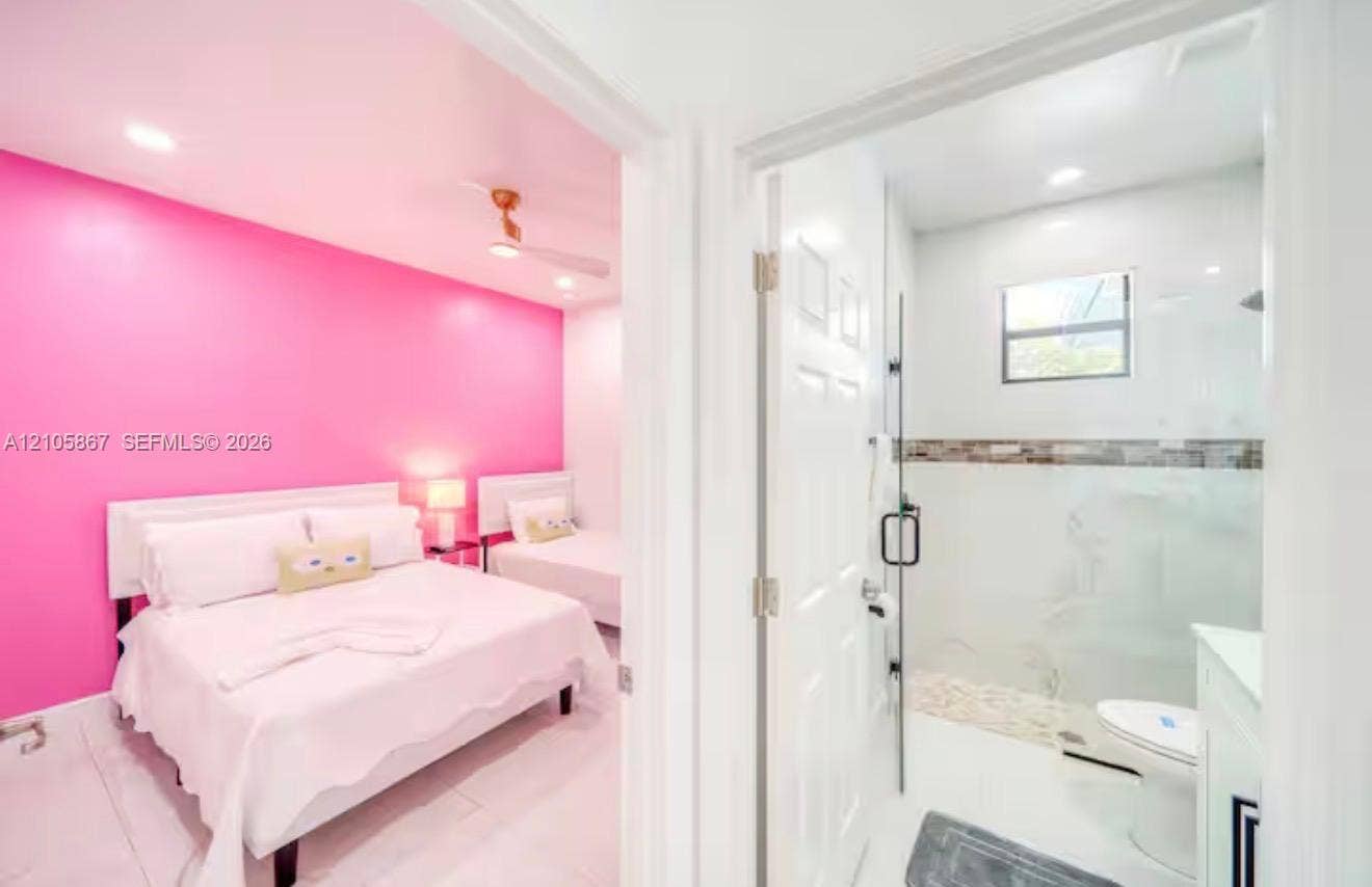 Bedroom featuring recessed lighting and a ceiling fan, accompanied by a bathroom with a glass-enclosed shower, mosaic tile wall accents, and light-toned tile flooring